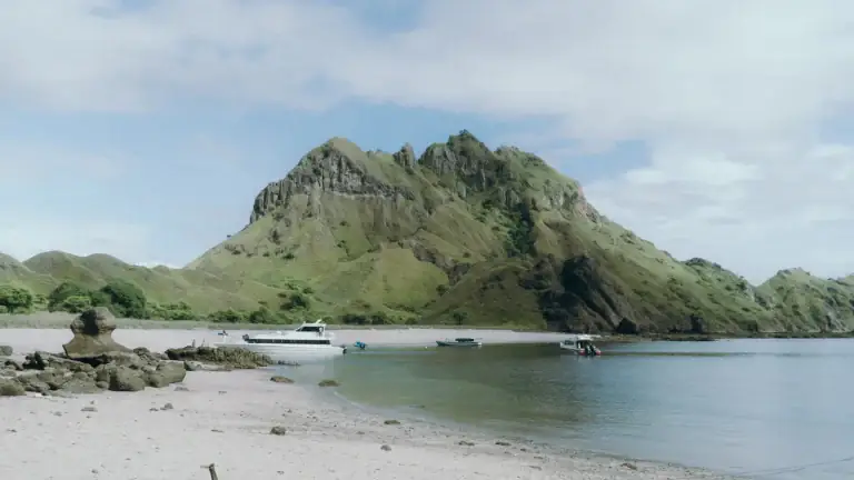 A small sandy beach backed by the hills of Padar Island