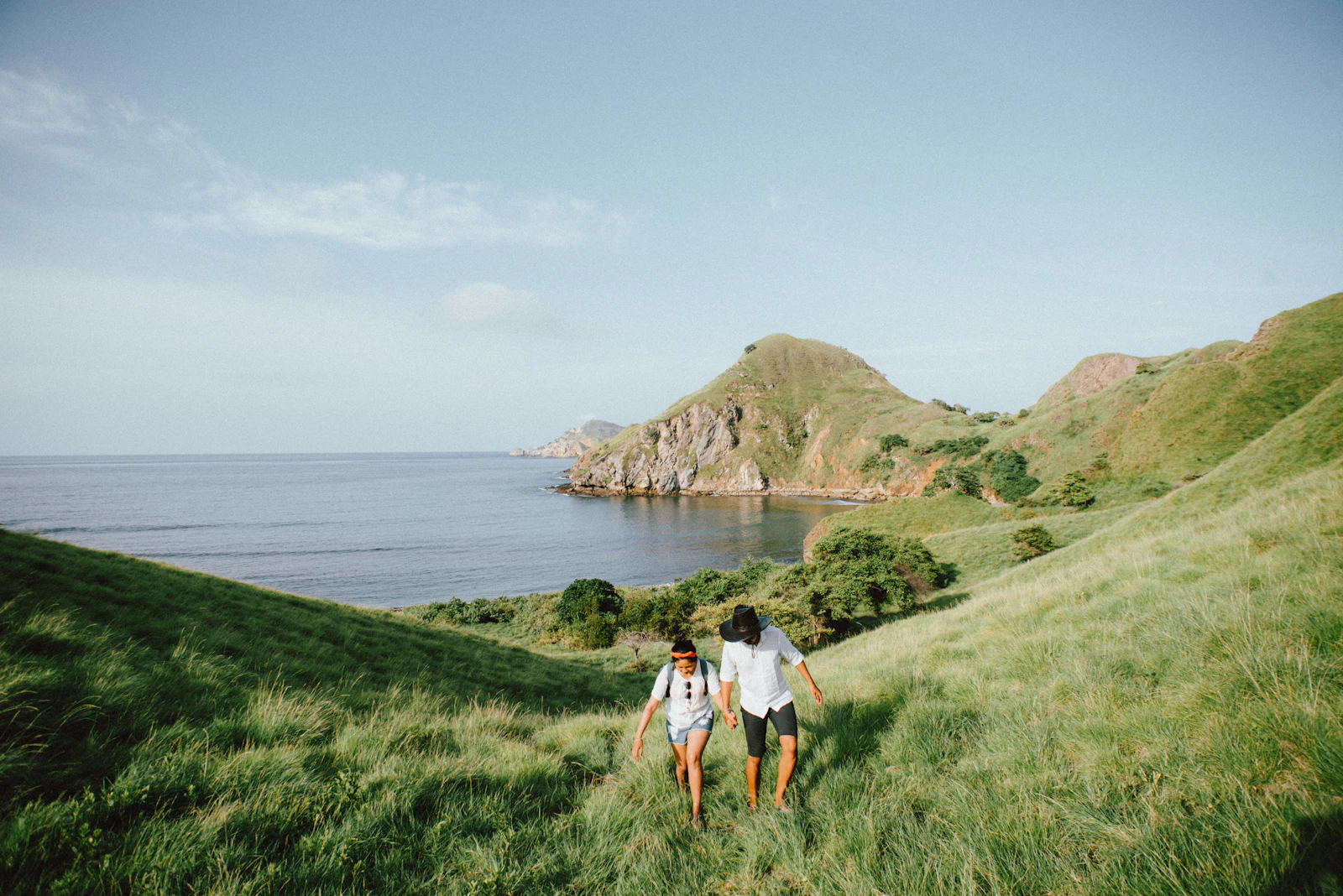 A couple walking along the hill trail on Padar Island at a relaxed pace