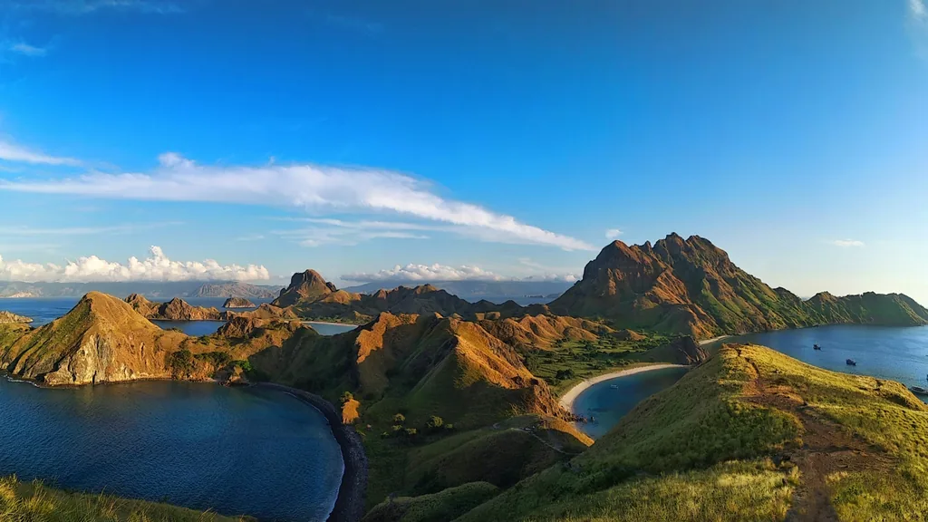 Sunrise light over Padar Island's ridgeline and bays seen from the summit trail