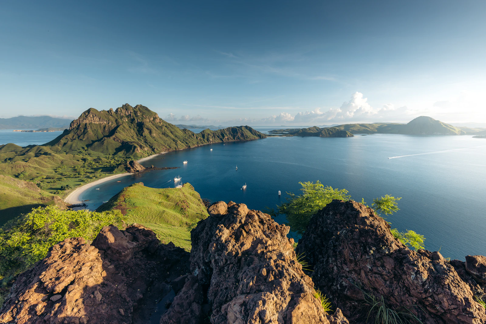 A panorama of Padar Island's hills and bays seen from the rocky summit viewpoint