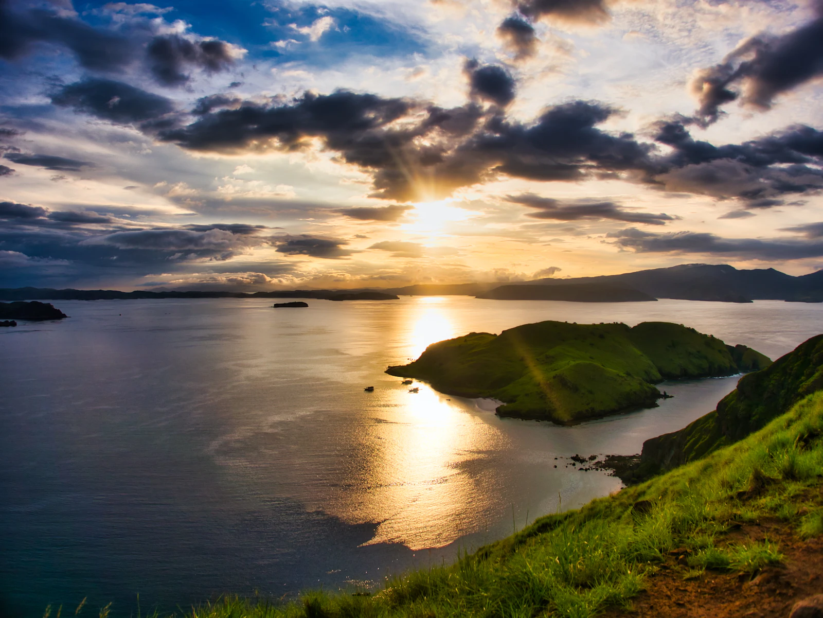 A panorama of golden dry-season savanna on Padar Island's hills