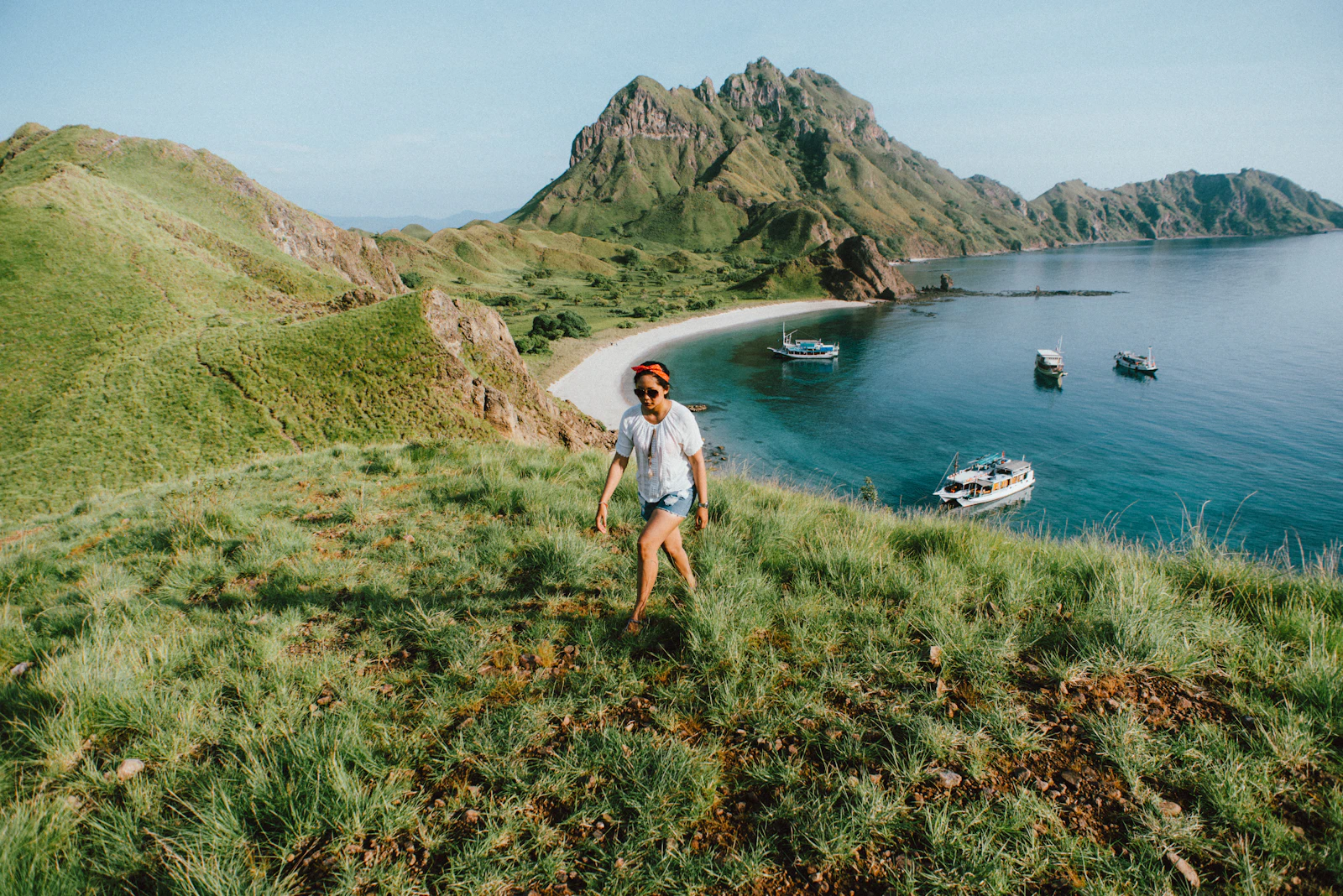 Visitors walking along the grassy trail toward the viewpoint on Padar Island