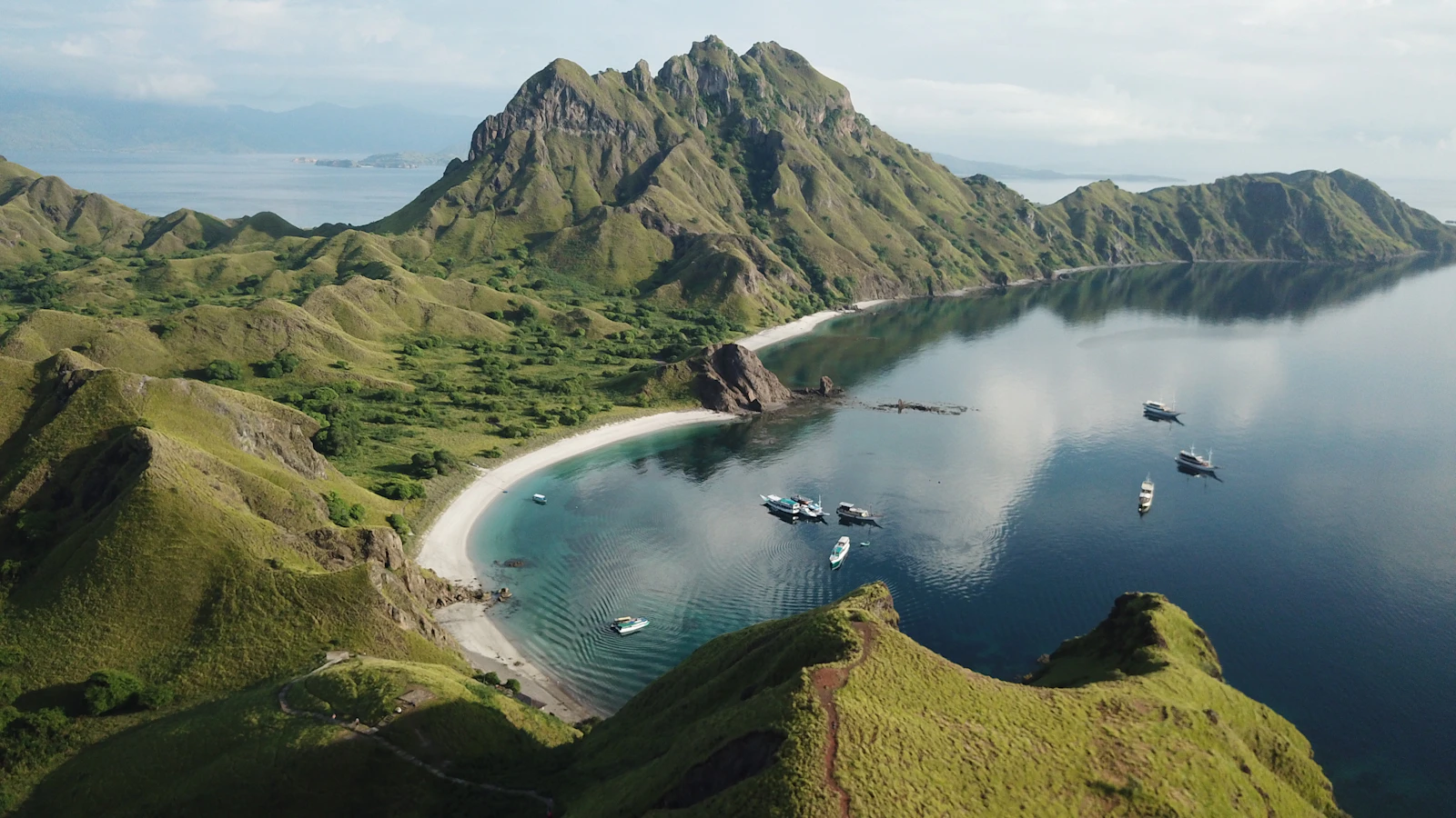 A trekking footpath on Padar Island with a bay view below