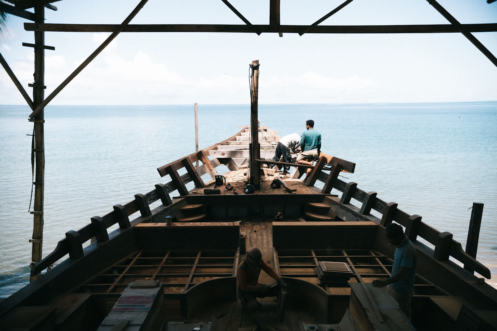 The process of building a traditional wooden boat at a shipyard, generic illustration not a photo of a specific location