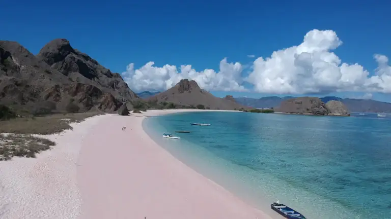 A small boat moored at the edge of Pink Beach