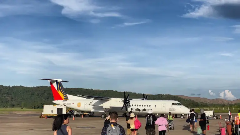 Passengers boarding a small aircraft on an airport apron