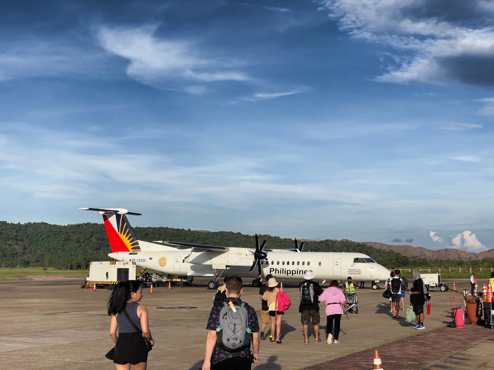 Passengers boarding a small aircraft on the airport tarmac