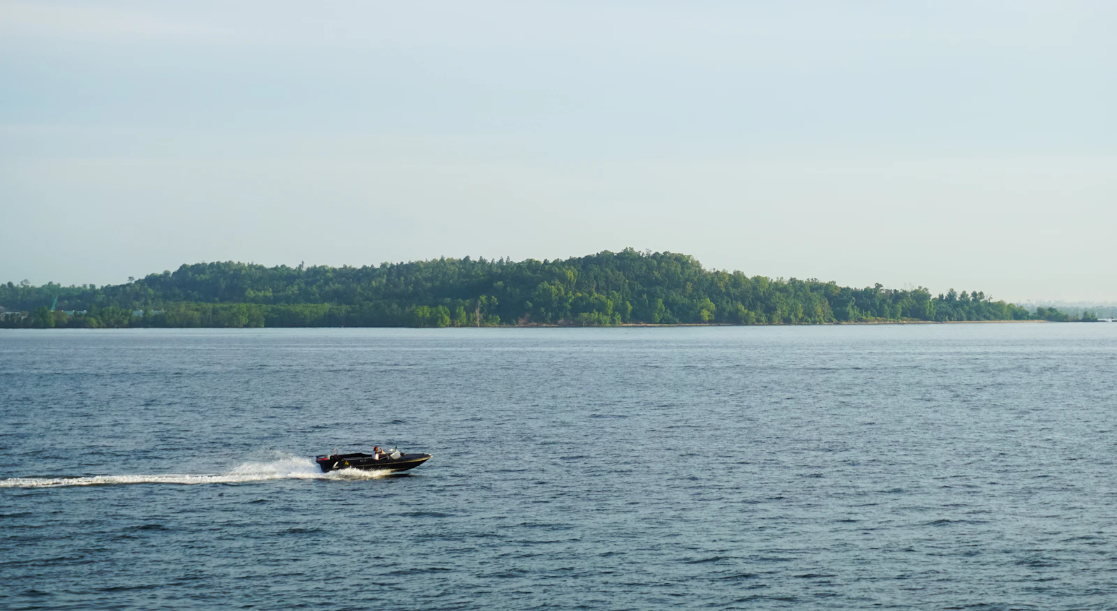 A speedboat crossing wide open sea water