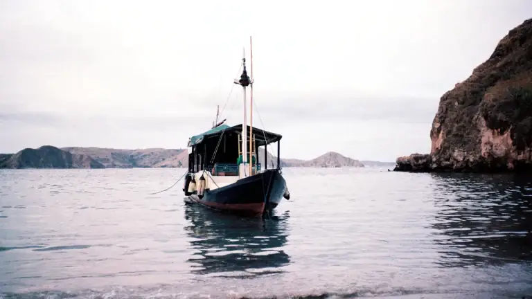 A traditional wooden boat moored at an island in the Flores region, Indonesia